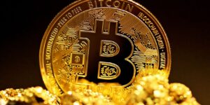 a picture showing bitcoin token and gold