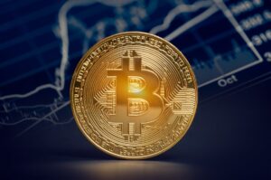 A gold coin with the Bitcoin symbol on its face.